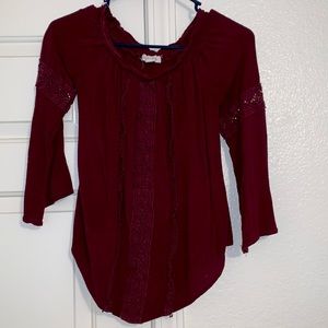 Maroon mid length blouse.